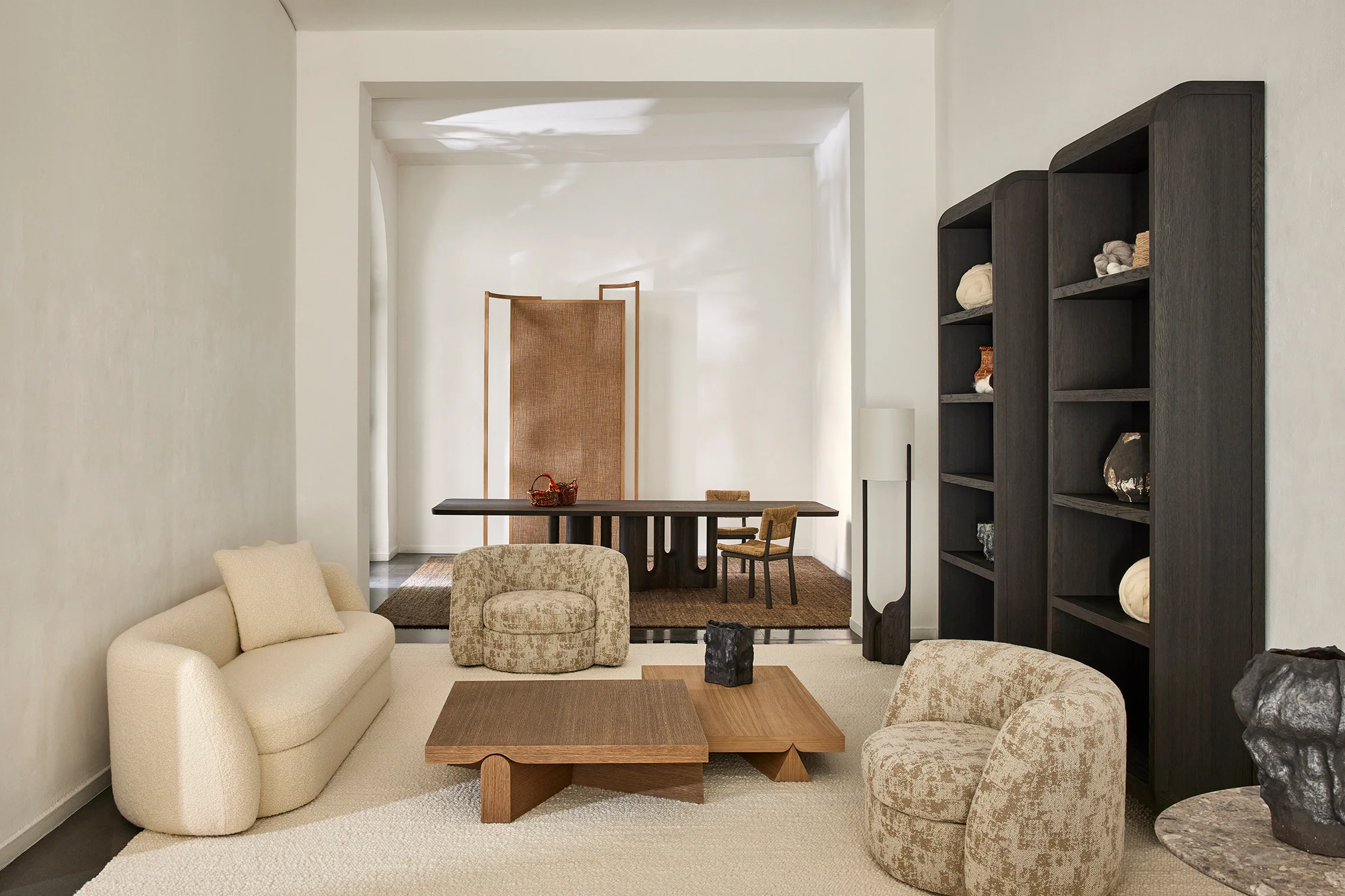  A refined and modern furniture collection from Christophe Delcourt, showcased in a beautifully lit Milan exhibition space, highlighting the seamless fusion of craftsmanship, organic materials, and contemporary design aesthetics.