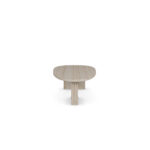 Oval travertine coffee table with two vertical slab legs and subtle brass accents, Landi by Nolita Harbour.