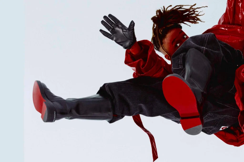 Jaden Smith announced as Creative Director at Louboutin, standing in a bold red jacket.