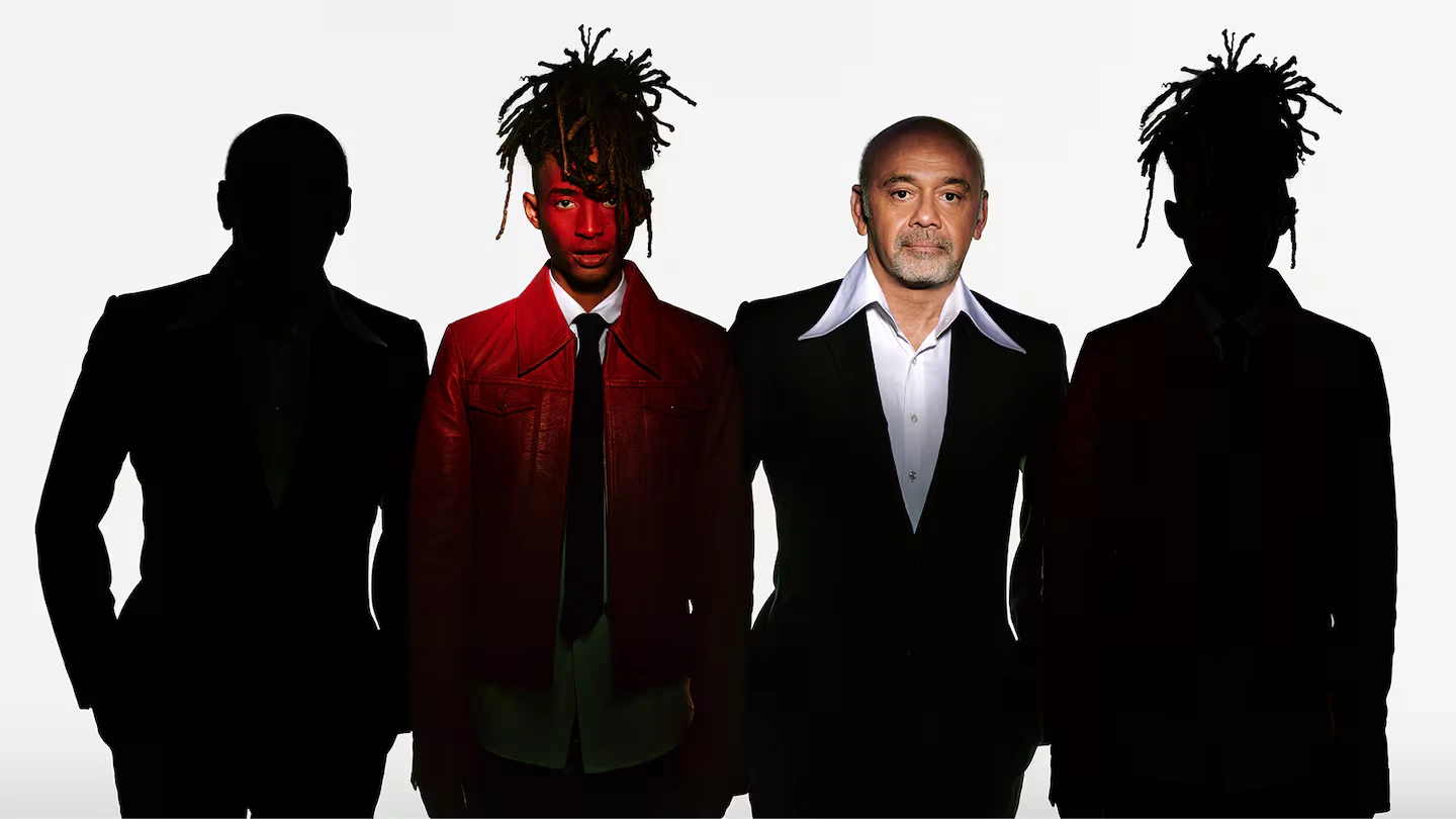 Jaden Smith at Louboutin announced as Creative Director , standing in a bold red jacket next to Christian Louboutin.