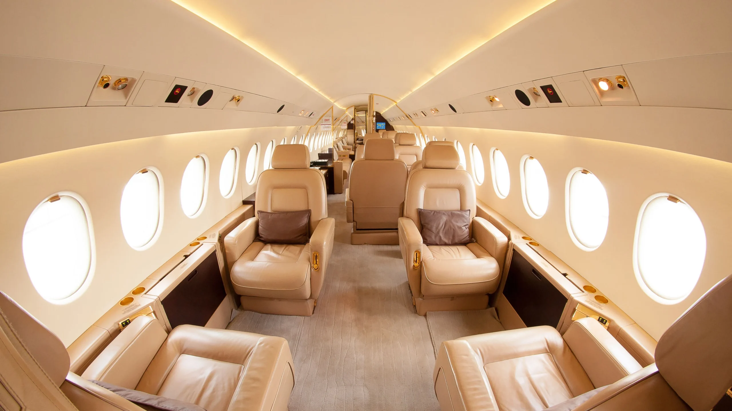 Luxury Travel private jet interior with leather seats, wood accents, and round windows offering an exclusive travel experience.