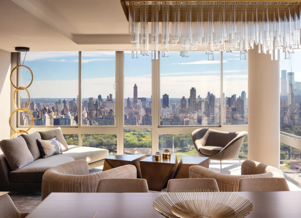 Luxury New York apartment interior overlooking Central Park, combining organic modern interior design, neutral palettes, and expansive floor-to-ceiling windows.