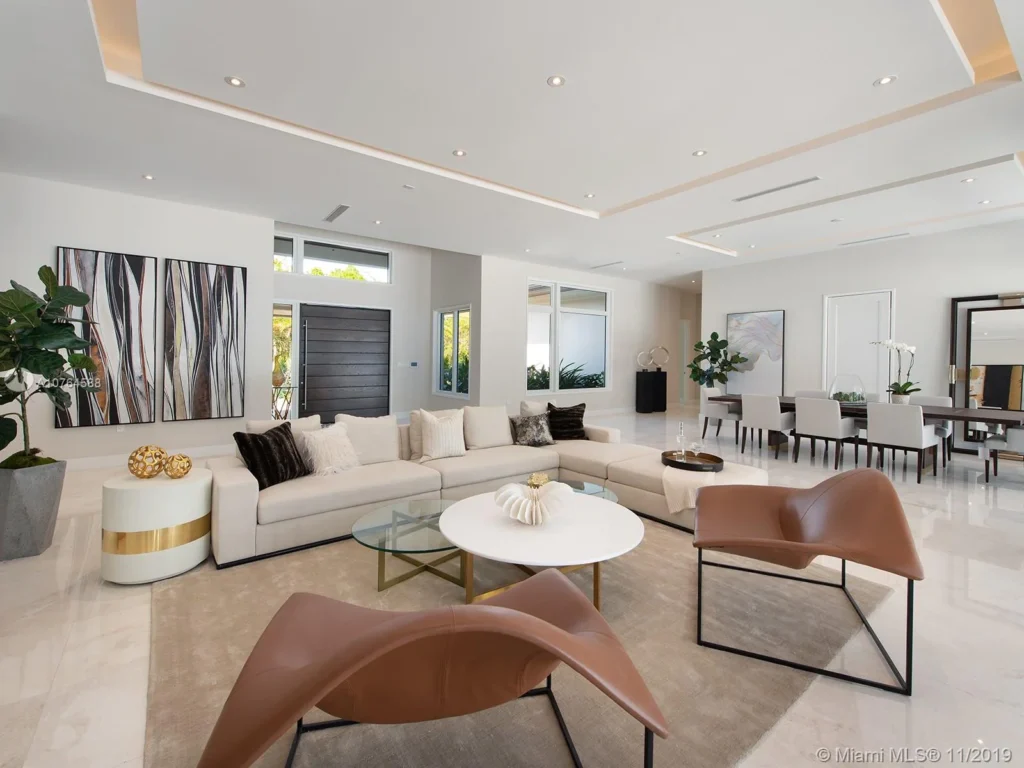 Miami luxury real estate interior showcasing an open-plan living space, neutral tones, and contemporary furnishings designed for indoor-outdoor living and modern coastal lifestyles.