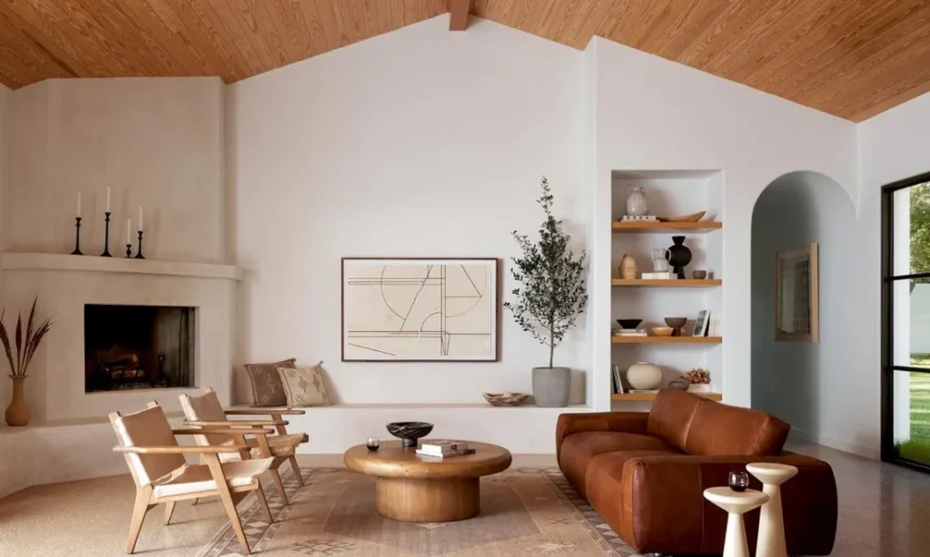 Coastal modern living room in a Riviera luxury home, featuring natural wood ceilings, sculptural furniture, textured plaster walls, and a warm Mediterranean modern architecture aesthetic.