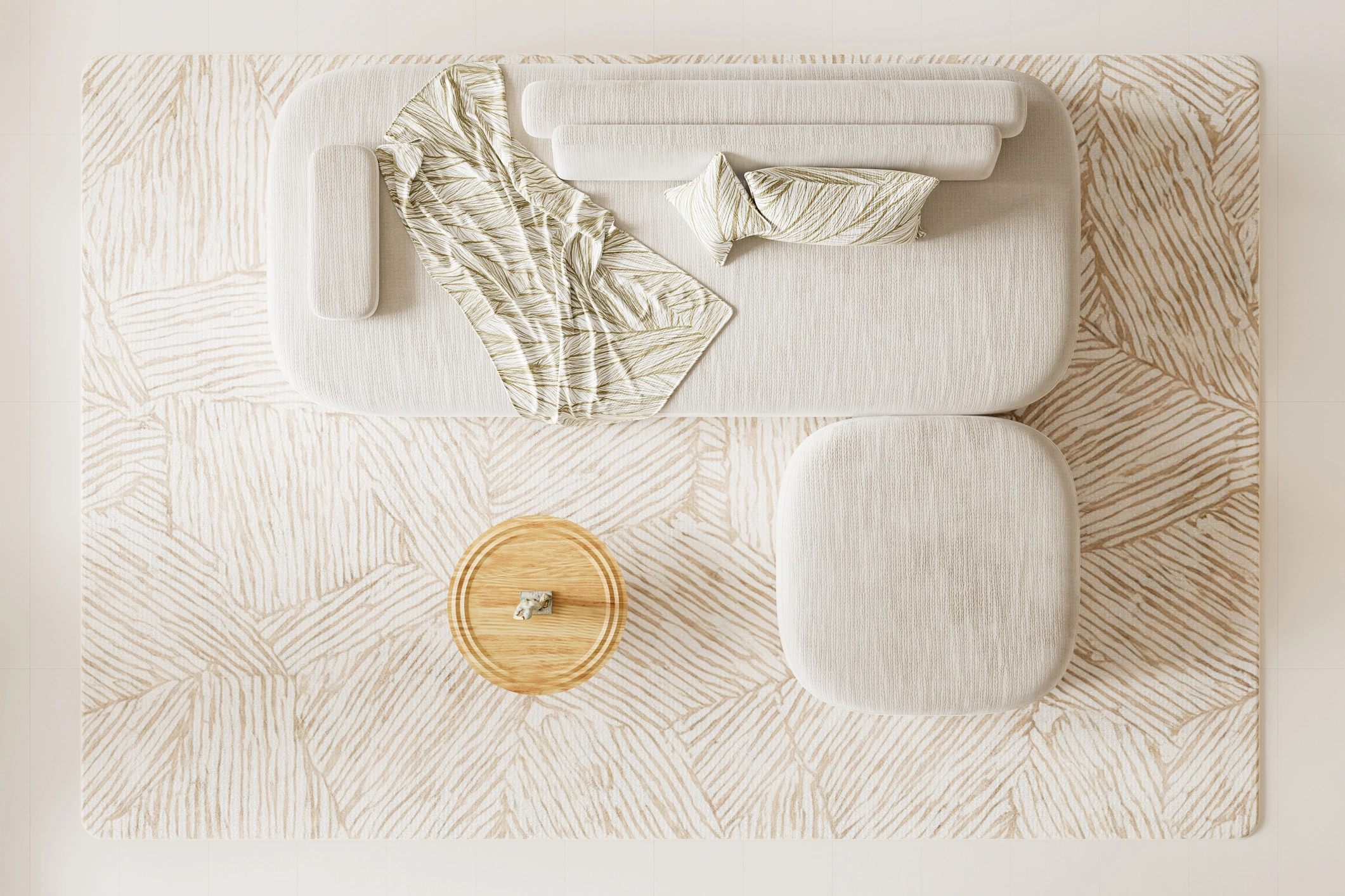 Contemporary living room viewed from above featuring a textured neutral rug, sculptural upholstered sofa, and layered textiles that emphasize tactile design over color.