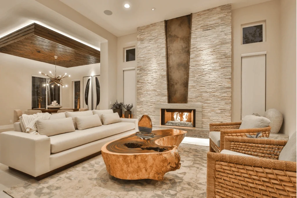 Luxury contemporary interior showcasing layered textures, including natural stone walls, warm wood ceiling panels, and soft neutral upholstery in a refined residential living space.
