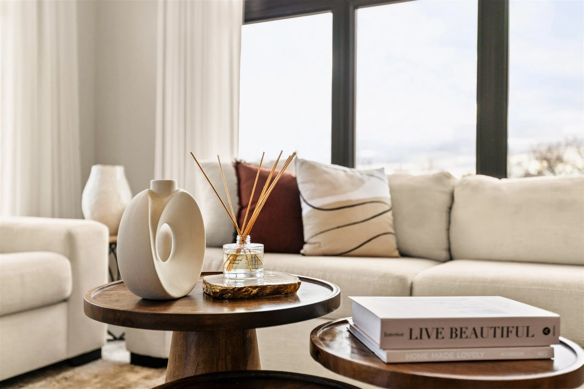Quiet luxury interior detail highlighting a minimalist coffee table styled with sculptural ceramics, neutral textiles, and subtle textures in a refined living space.