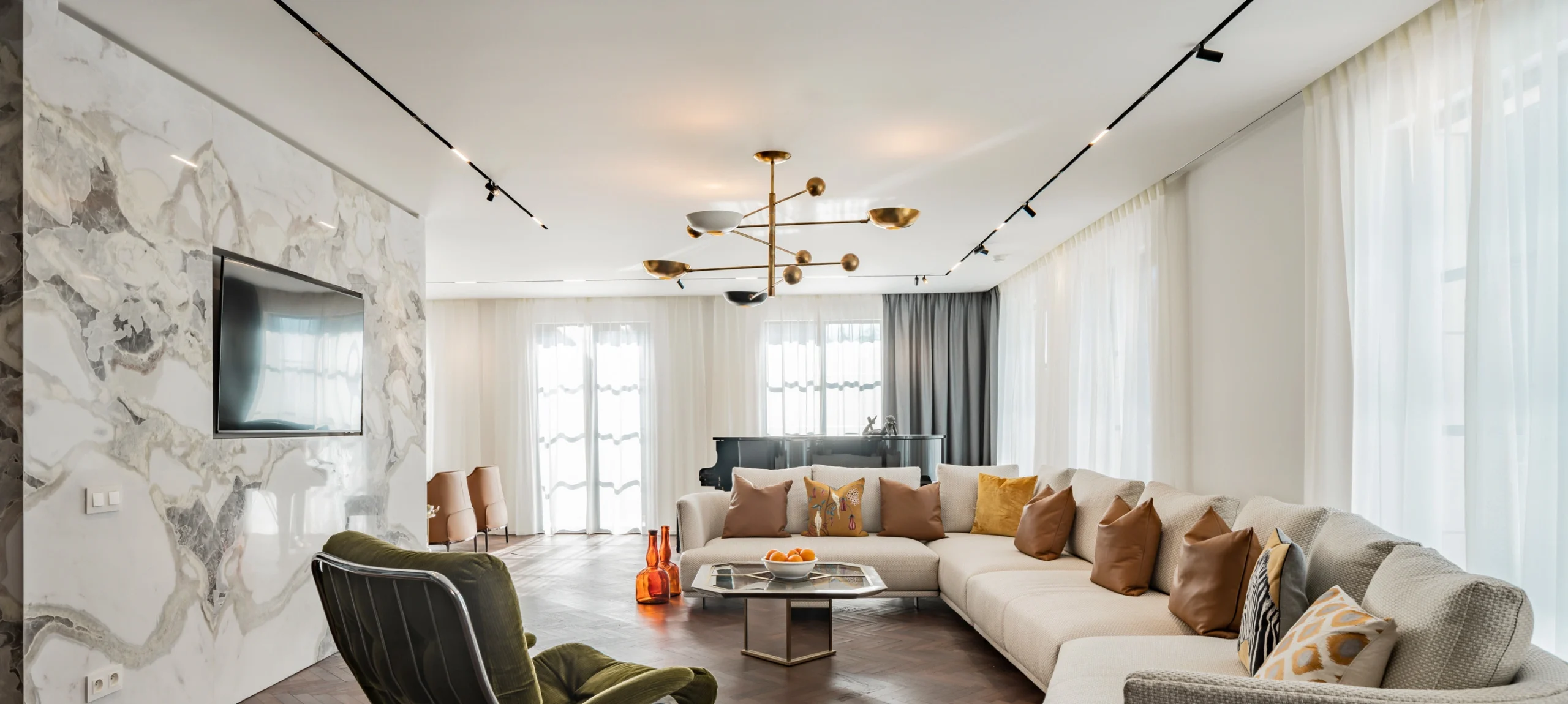 Modern dining room illustrating the harmony of ambient lighting and functional lighting, featuring a central pendant, wall sconces, and natural light to support both atmosphere and everyday use.