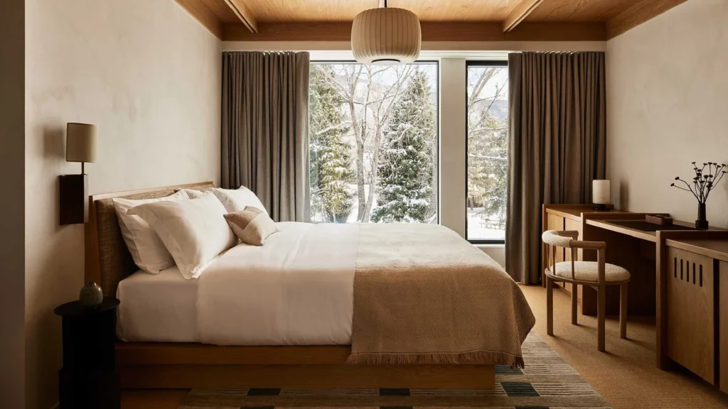 Aspen luxury homes showcasing refined mountain home interior design and seasonal residence furnishing, featuring contemporary alpine architecture, natural wood and stone materials, panoramic mountain views, elegant living rooms with fireplaces, and seamless indoor-outdoor living in Colorado.