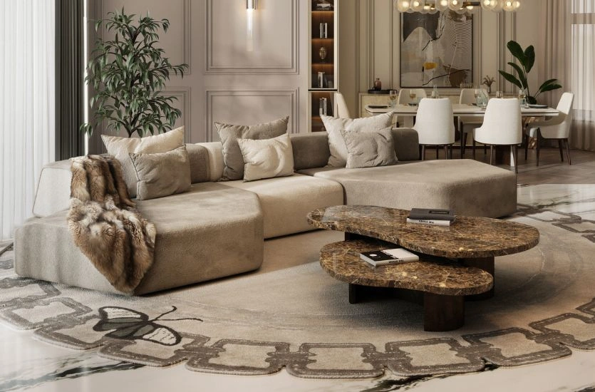 High-end living room showcasing a modular contemporary sofa, organic stone coffee tables, and layered textures, reflecting contemporary furniture trends translated from design fairs into residential interiors.