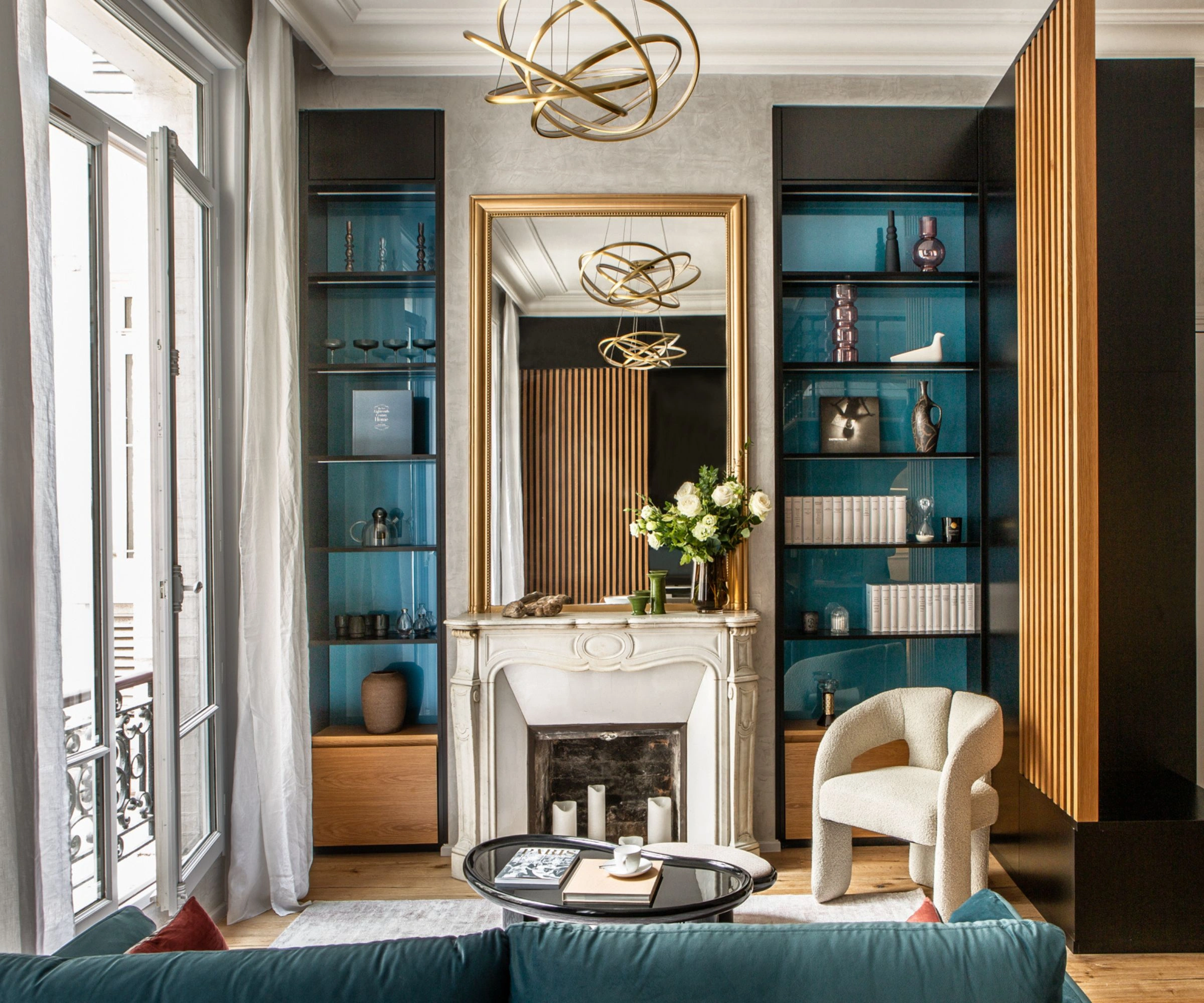 Luxury interior design combining classical fireplace details with modern furnishings, bespoke shelving, sculptural lighting, and refined materials inspired by contemporary Milanese design.