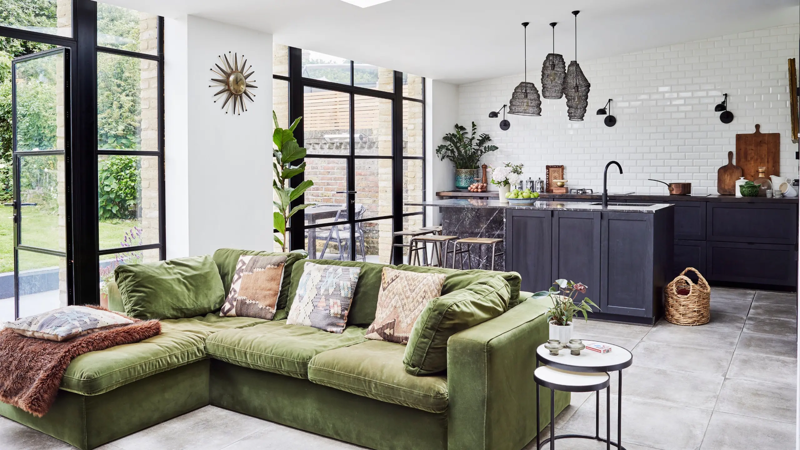 Contemporary Milanese apartment showcasing open-plan living and dining, with sculptural furniture, warm wood finishes, curated art, and expansive windows that create a seamless, light-filled European interior.