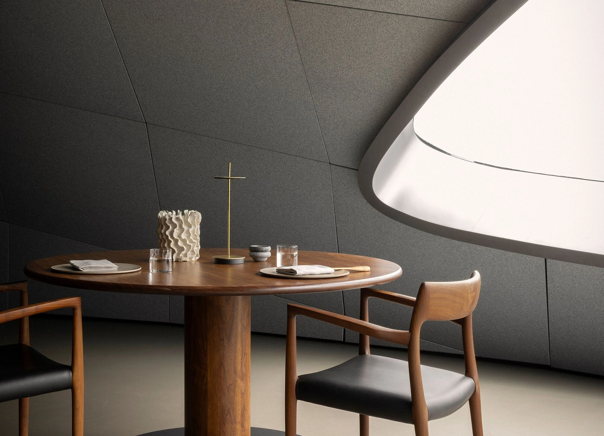 Norm Architects team and selected studio and project interiors showcasing contemporary seating design, minimalist furniture design, and material-driven calm through natural wood, neutral upholstery, and serene architectural settings.