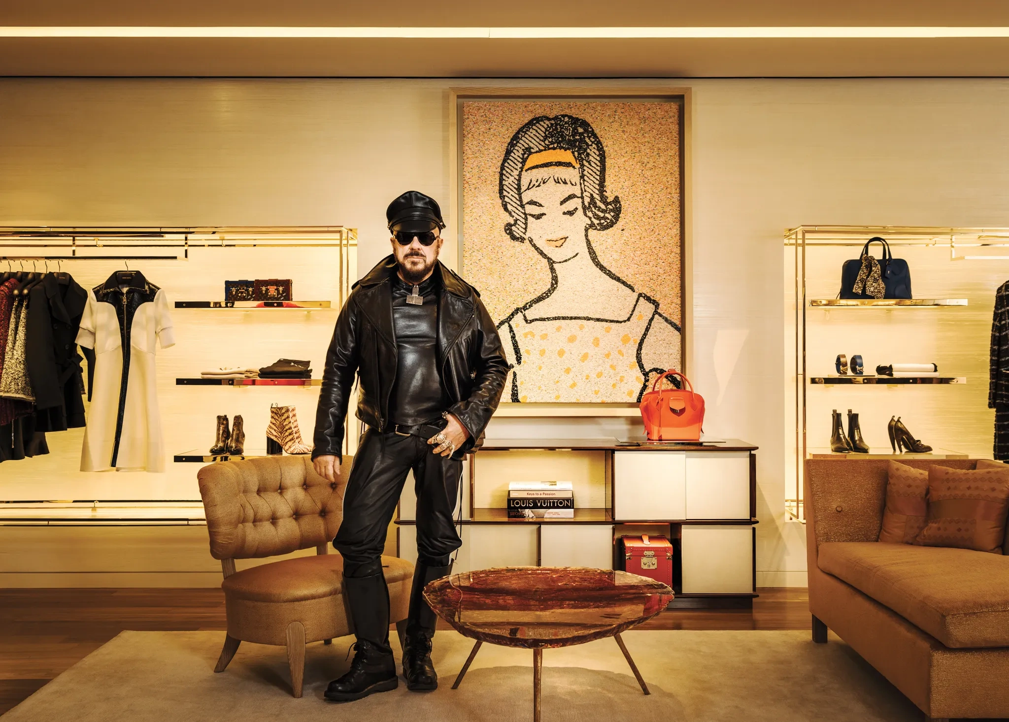 Peter Marino photographed inside a Louis Vuitton interior he designed, embodying his signature aesthetic of black leather, contemporary art, and architectural precision within luxury environments.