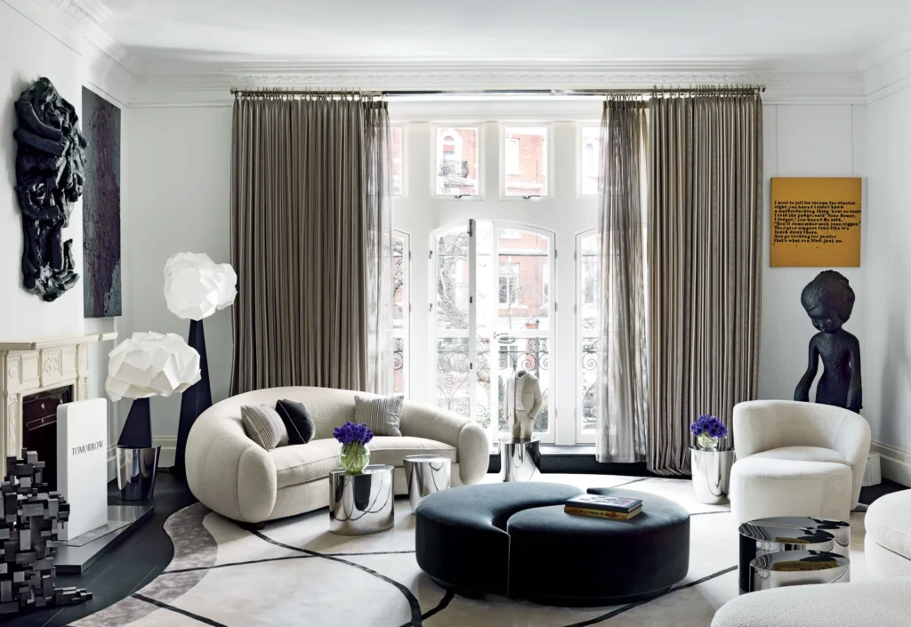 Luxury living room interiors featuring modular sectional sofas with corner modules and chaise lounge units, styled with statement ottomans, layered textiles, and contemporary décor in refined, light-filled residential settings.