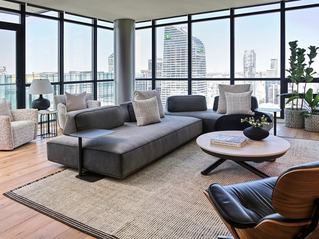 Spacious luxury living rooms featuring elegant sectional sofas thoughtfully positioned to balance scale and circulation, with refined materials, layered seating, and abundant natural light enhancing sophisticated open-plan layouts.