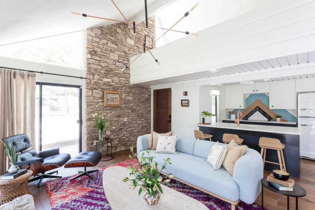 Modern luxury living rooms featuring sculptural swivel armchairs in leather and velvet, styled within contemporary open-plan interiors with double-height windows, curated artwork, and refined architectural details.