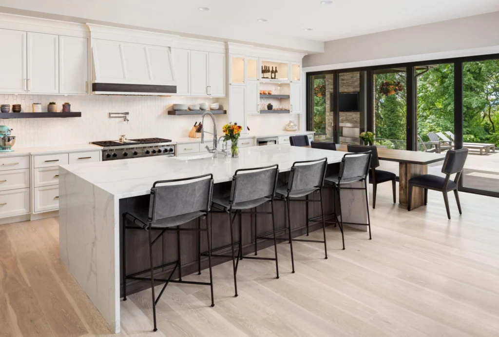 Open-plan kitchen with extended island and modern bar stools, presenting practical bar stools for kitchen island layouts designed for social living and entertaining.