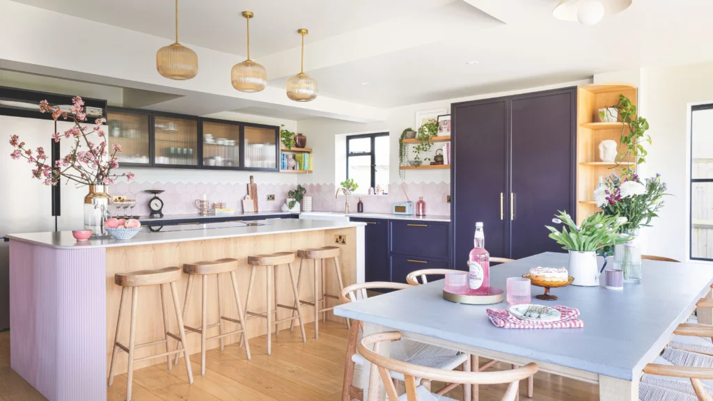 Bright kitchen interior with wooden bar stools at a breakfast bar, illustrating relaxed kitchen island seating ideas that combine natural materials and modern design.
