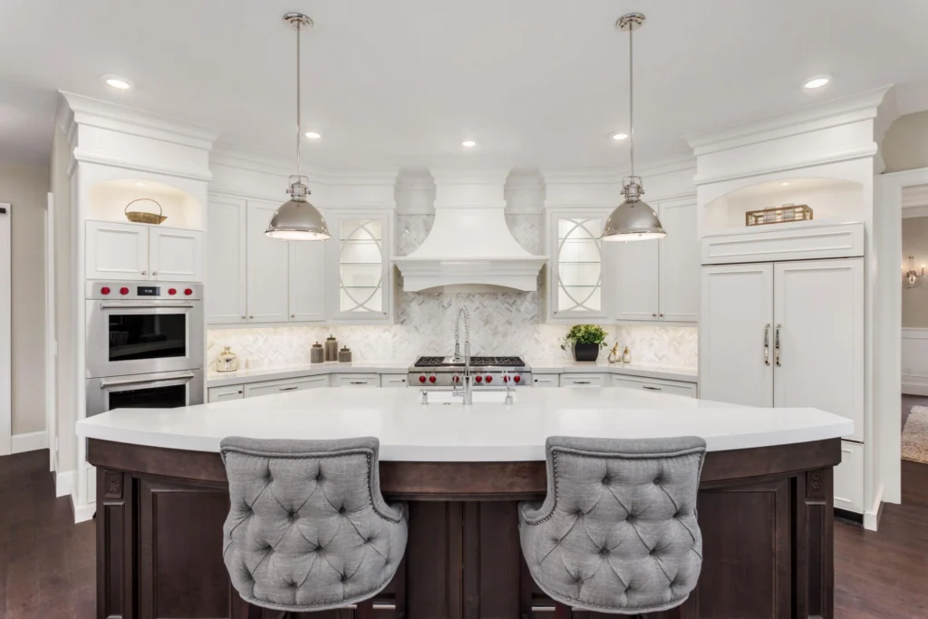 Luxury kitchen breakfast bar with tufted bar stools, highlighting timeless kitchen island seating ideas that blend comfort, craftsmanship, and architectural symmetry.