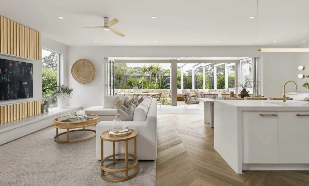 Luxury Hamptons-style East Coast summer home showcasing open-plan coastal interiors, cedar-shingle architecture, landscaped gardens, and a refined infinity pool setting that embodies timeless luxury coastal living.