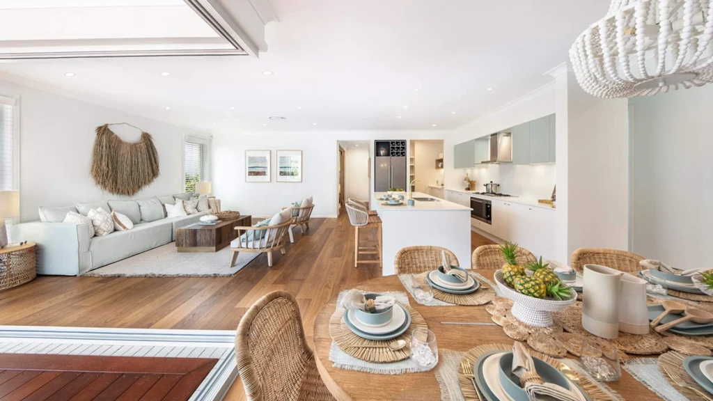 Luxury Hamptons-style East Coast summer home showcasing open-plan coastal interiors, cedar-shingle architecture, landscaped gardens, and a refined infinity pool setting that embodies timeless luxury coastal living.