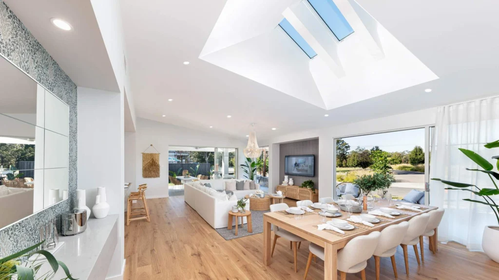 Architectural interior featuring exposed concrete and warm wood ceilings, with built-in shelving and furniture integrated seamlessly into the structural design.