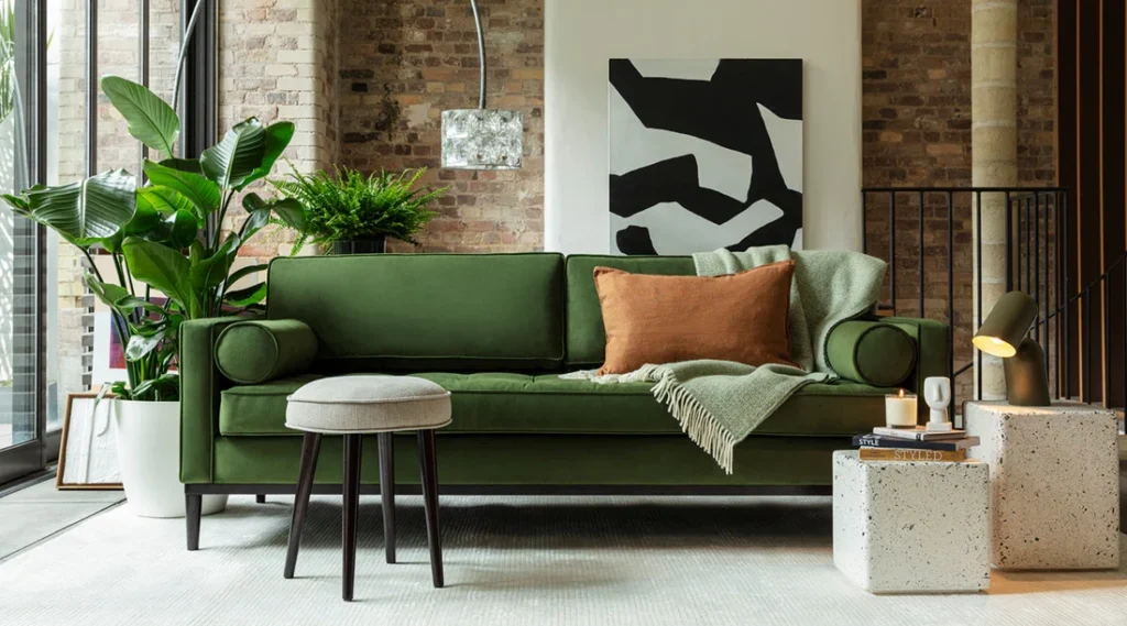 Modern living room featuring a green velvet sofa styled with cushions and accessories, demonstrating timeless design and best practices for velvet upholstery care.