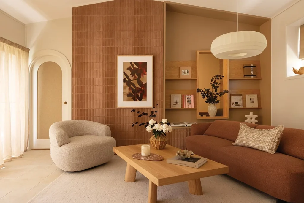 Warm-toned luxury living room with bespoke furniture, layered textures, and soft lighting, reflecting evolving luxury interior design trends focused on comfort and emotional well-being.